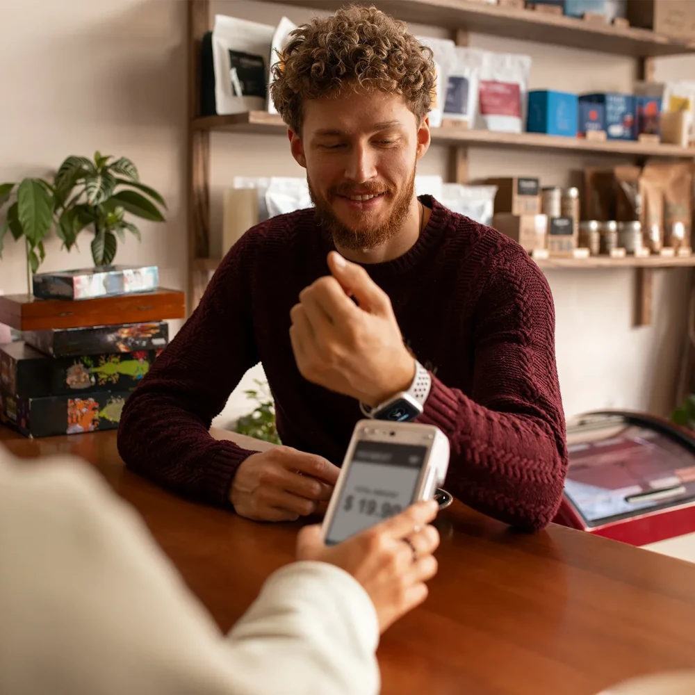 A shop worker handling a transaction with a customer